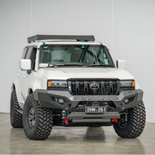 White Toyota truck with off-road modifications in a studio setting